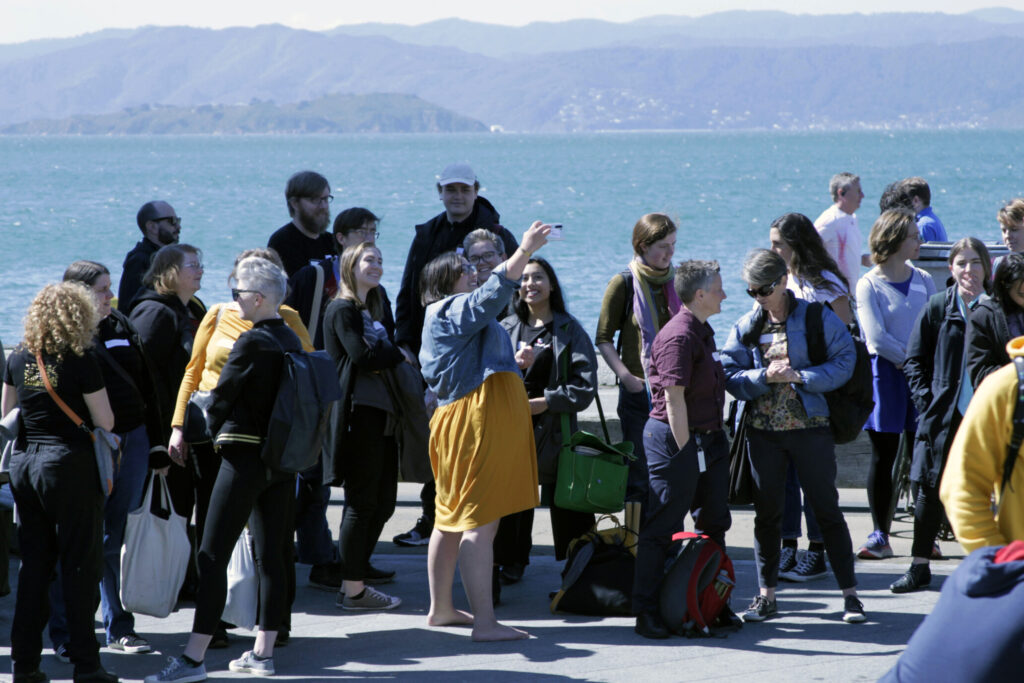 Manuhiri gather on the waterfront as they wait for the event and pōwhiri to start